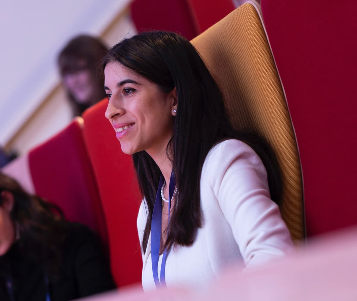 Dilem Kaya listening during a panel conversation